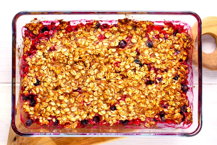 Baking dish of golden oat bake with strawberries