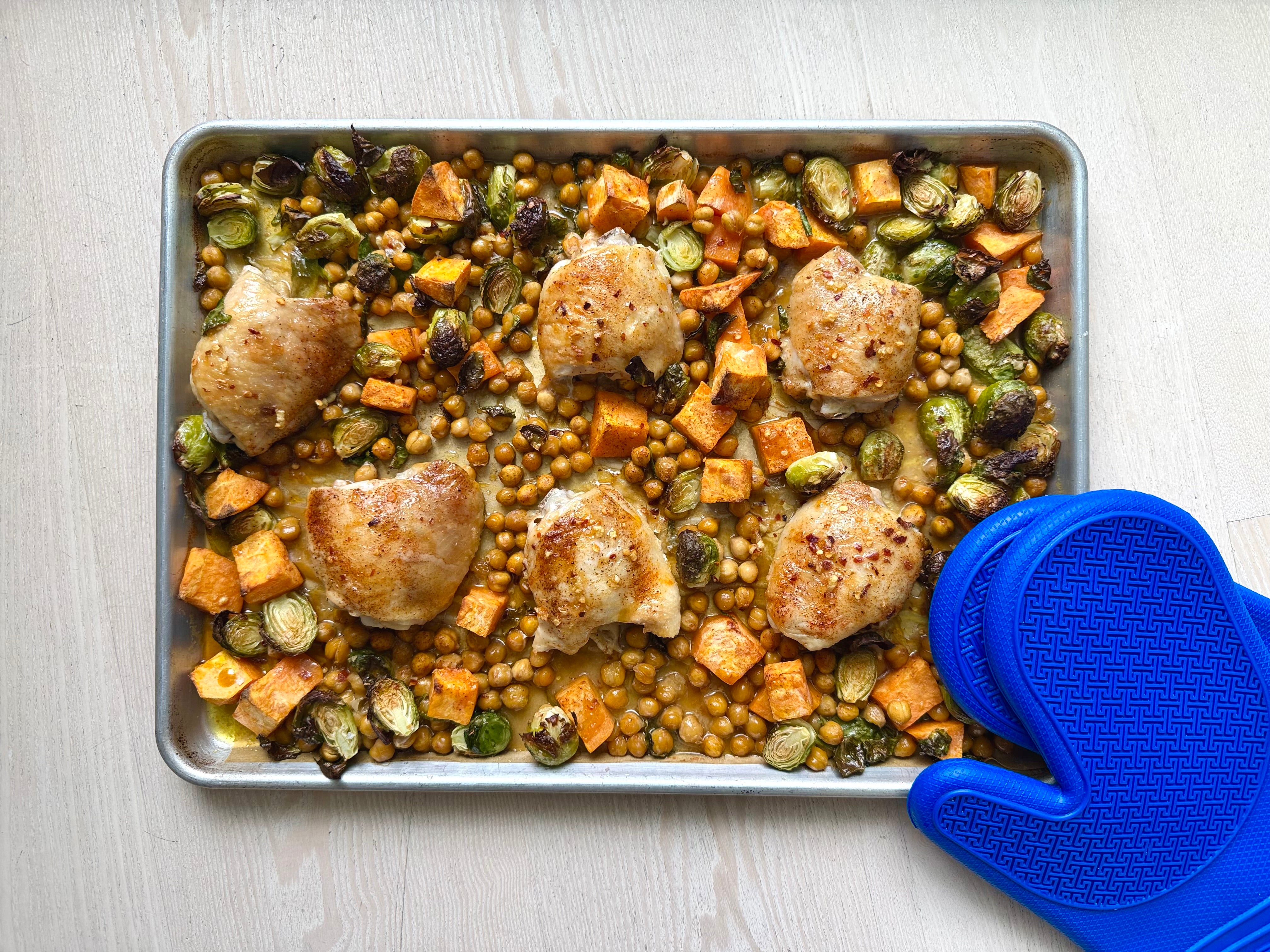 Sheet pan of maple chili chicken with roasted vegetables and chickpeas